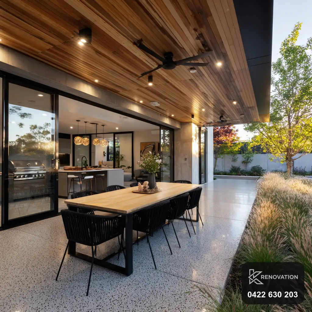 Covered alfresco dining area with timber ceiling and glazing by KRenovation