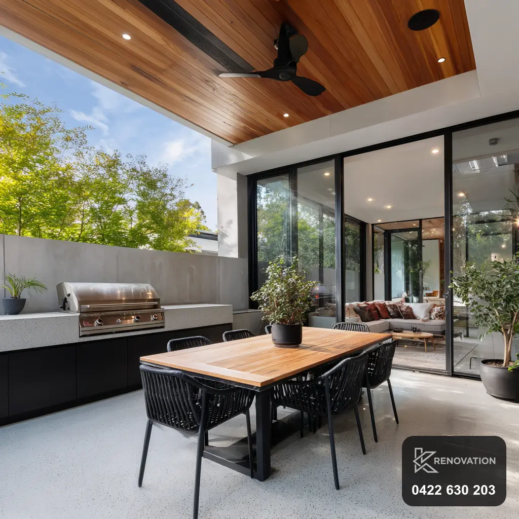 Covered alfresco living and dining area with timber ceiling by KRenovation
