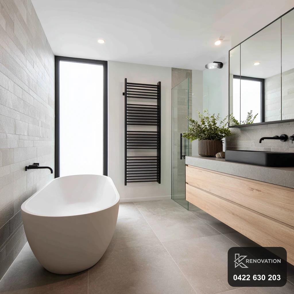 Renovated bathroom with freestanding bath and double vanity in Williamstown by KRenovation