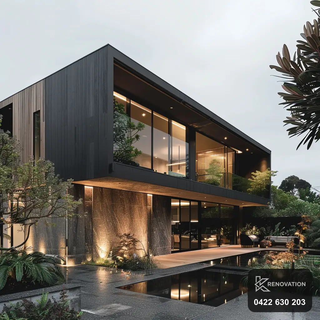 Two-storey renovated and extended home in dark timber at dusk by KRenovation