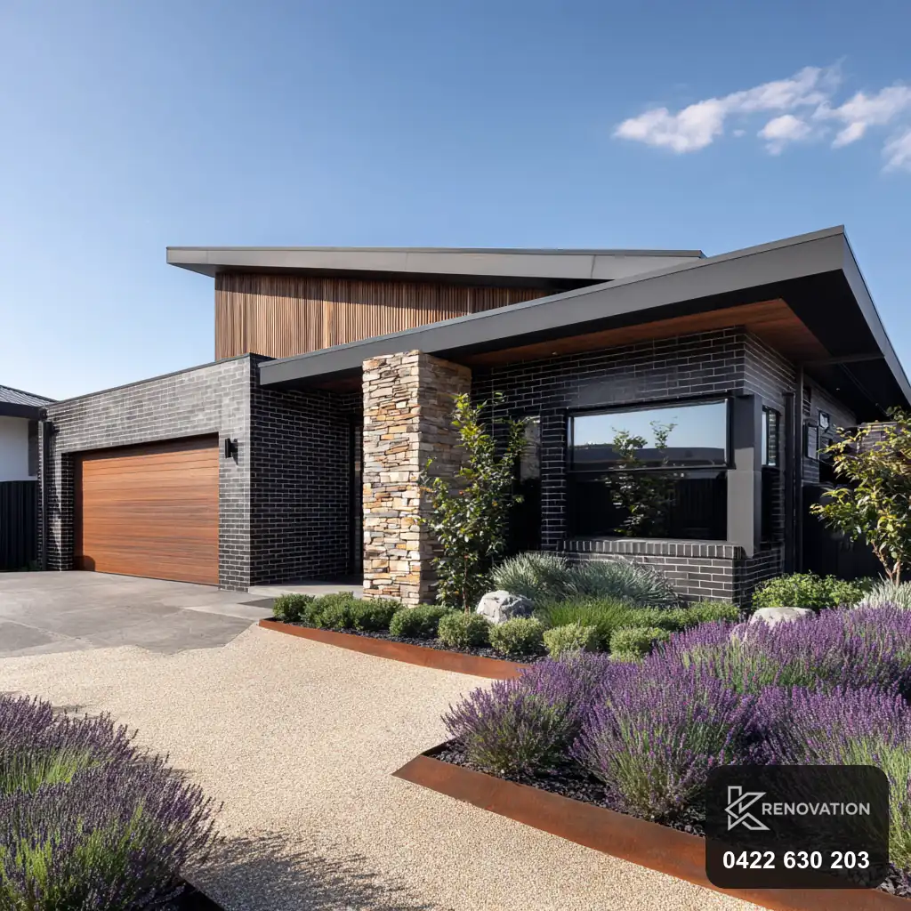 Extended home with stone and timber facade at dusk by KRenovation