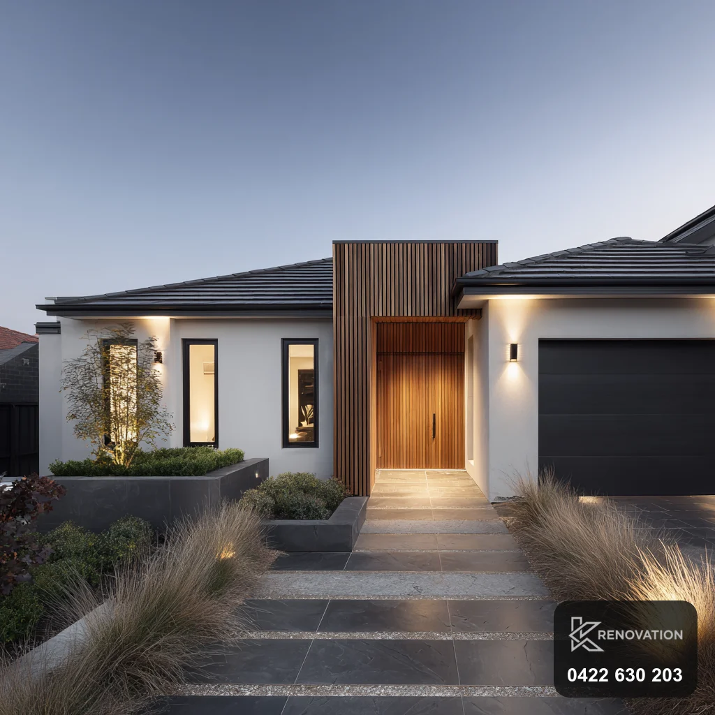 Home with a rear extension and deck entry in timber and dark cladding by KRenovation