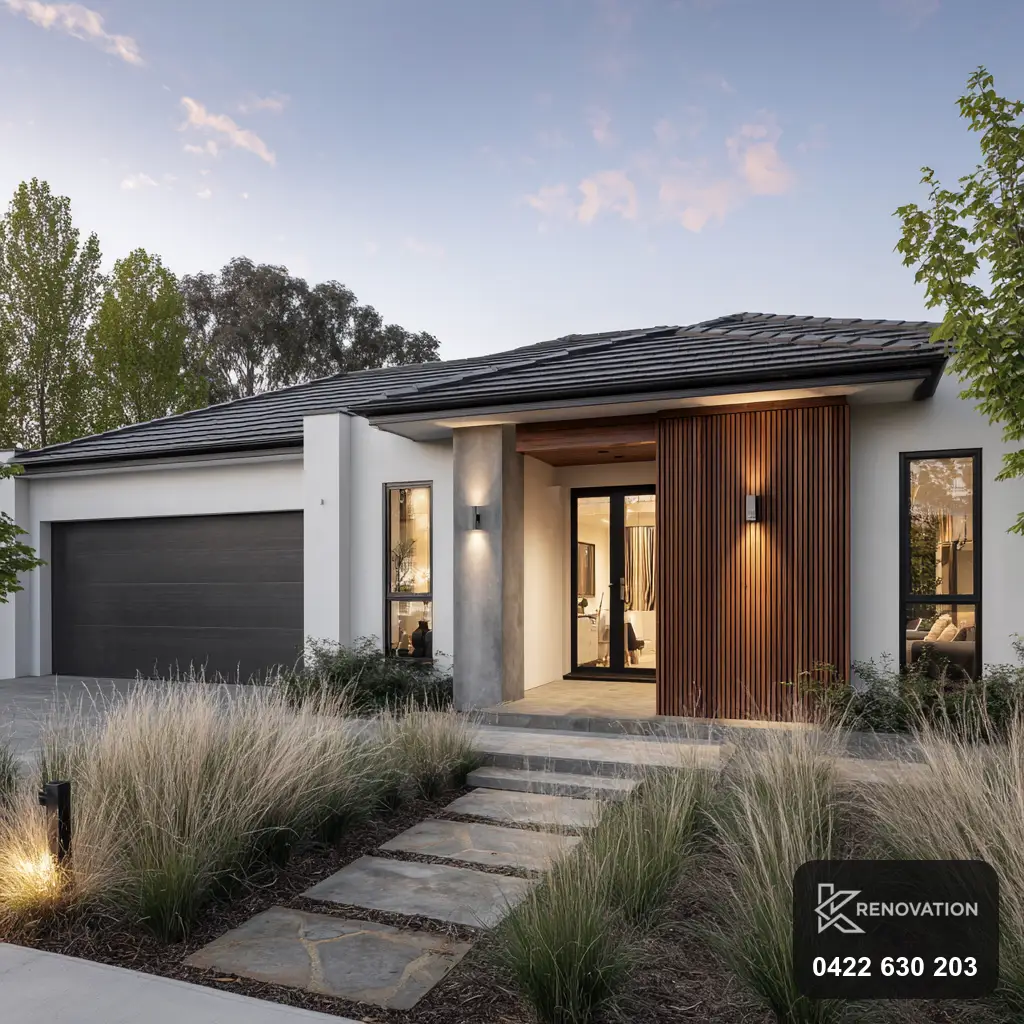 Extended modern home in timber and dark cladding lit at dusk by KRenovation