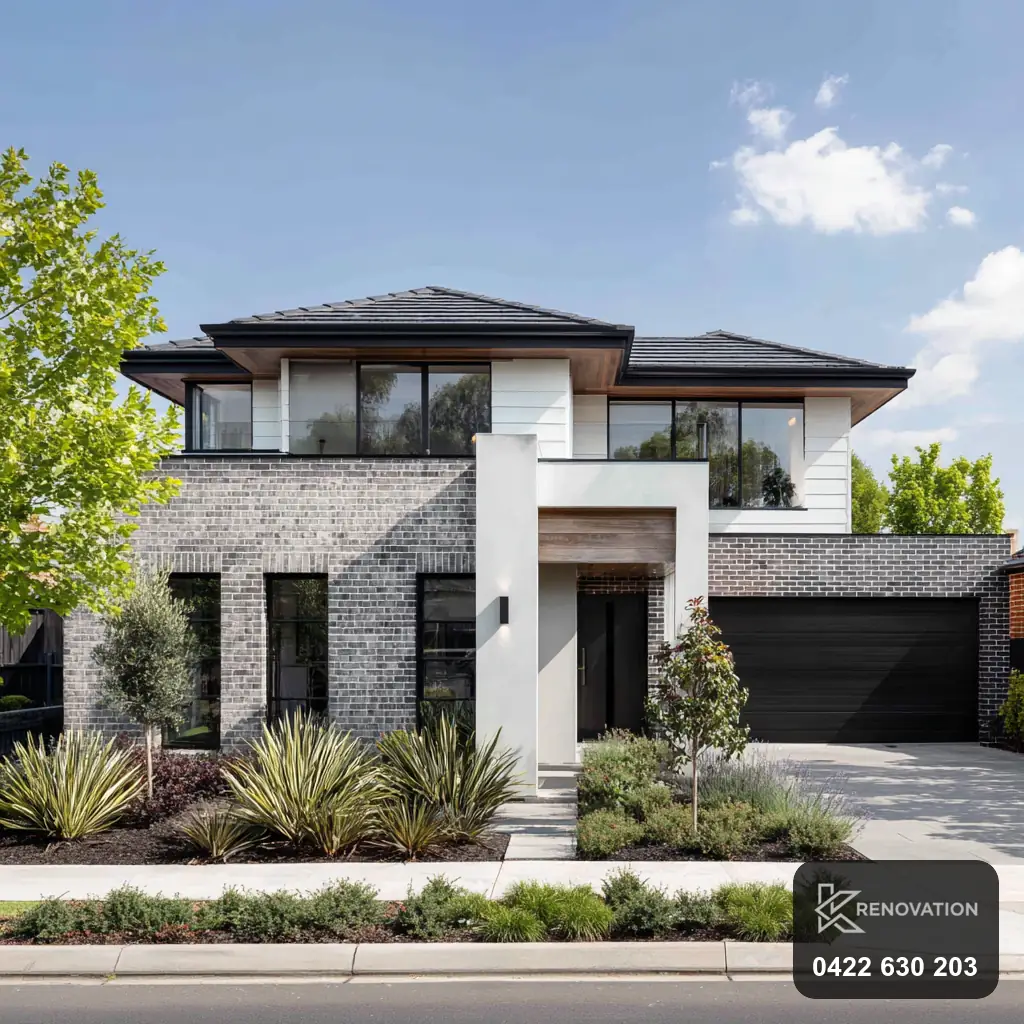 Two-storey home with render and dark accents after an extension by KRenovation