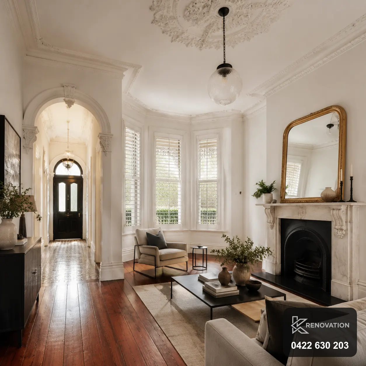 Renovated living room with arched windows and fireplace in Williamstown by KRenovation