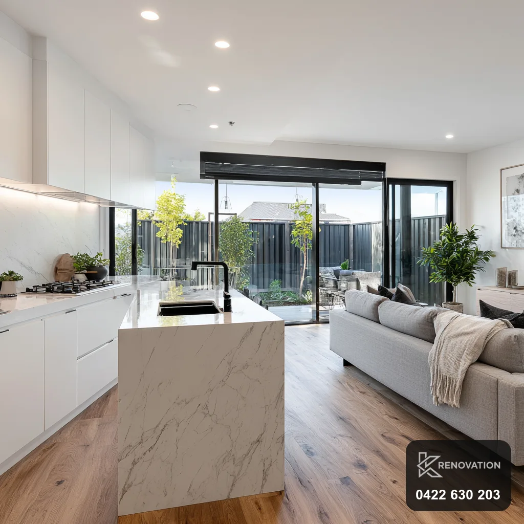 Open-plan living and kitchen with large glazing in a Spotswood home by KRenovation