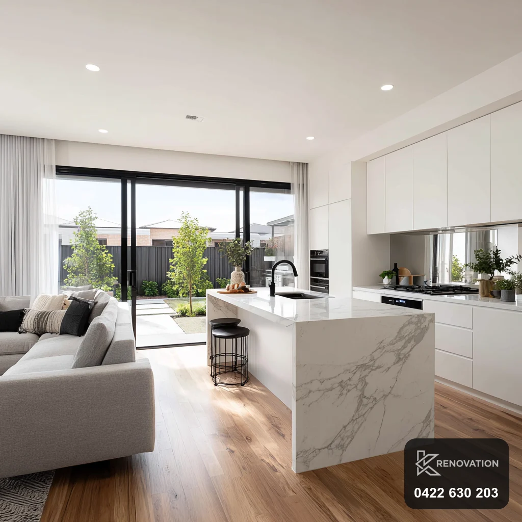 Renovated open-plan living room with large windows in Williamstown by KRenovation