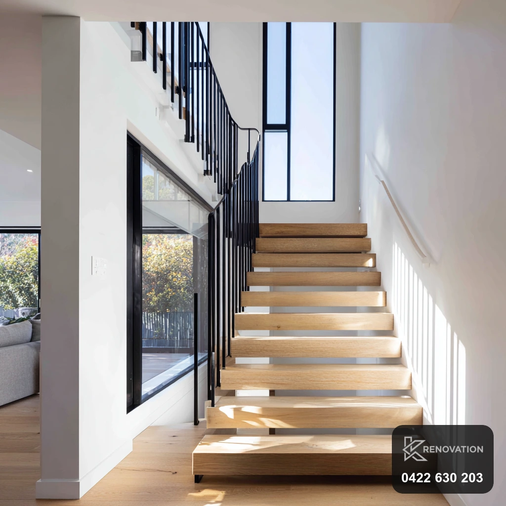 New internal staircase with white walls and black balustrade in a second-storey addition by KRenovation
